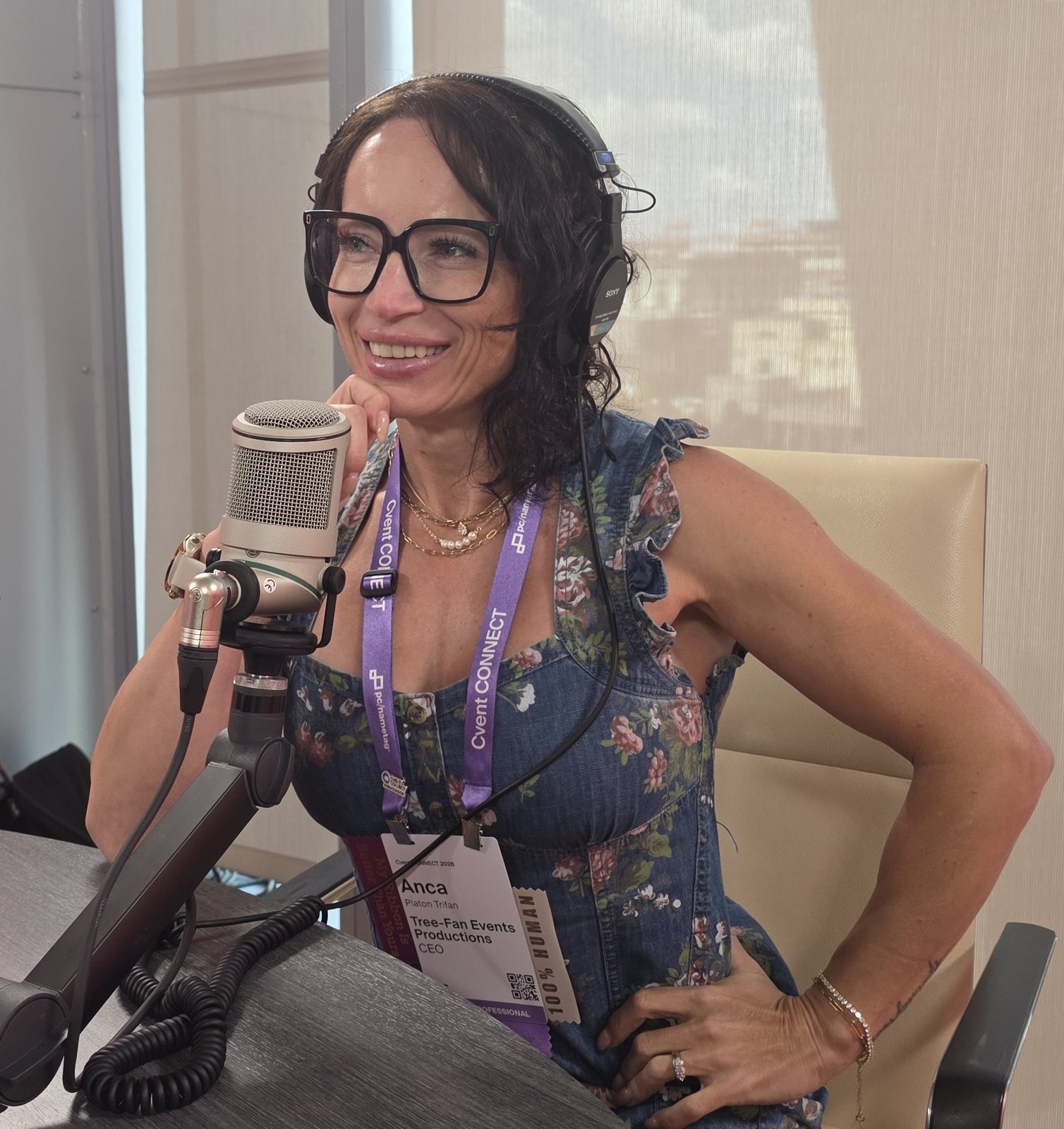 Anca Platon Trifan wearing headphones at a podcast microphone