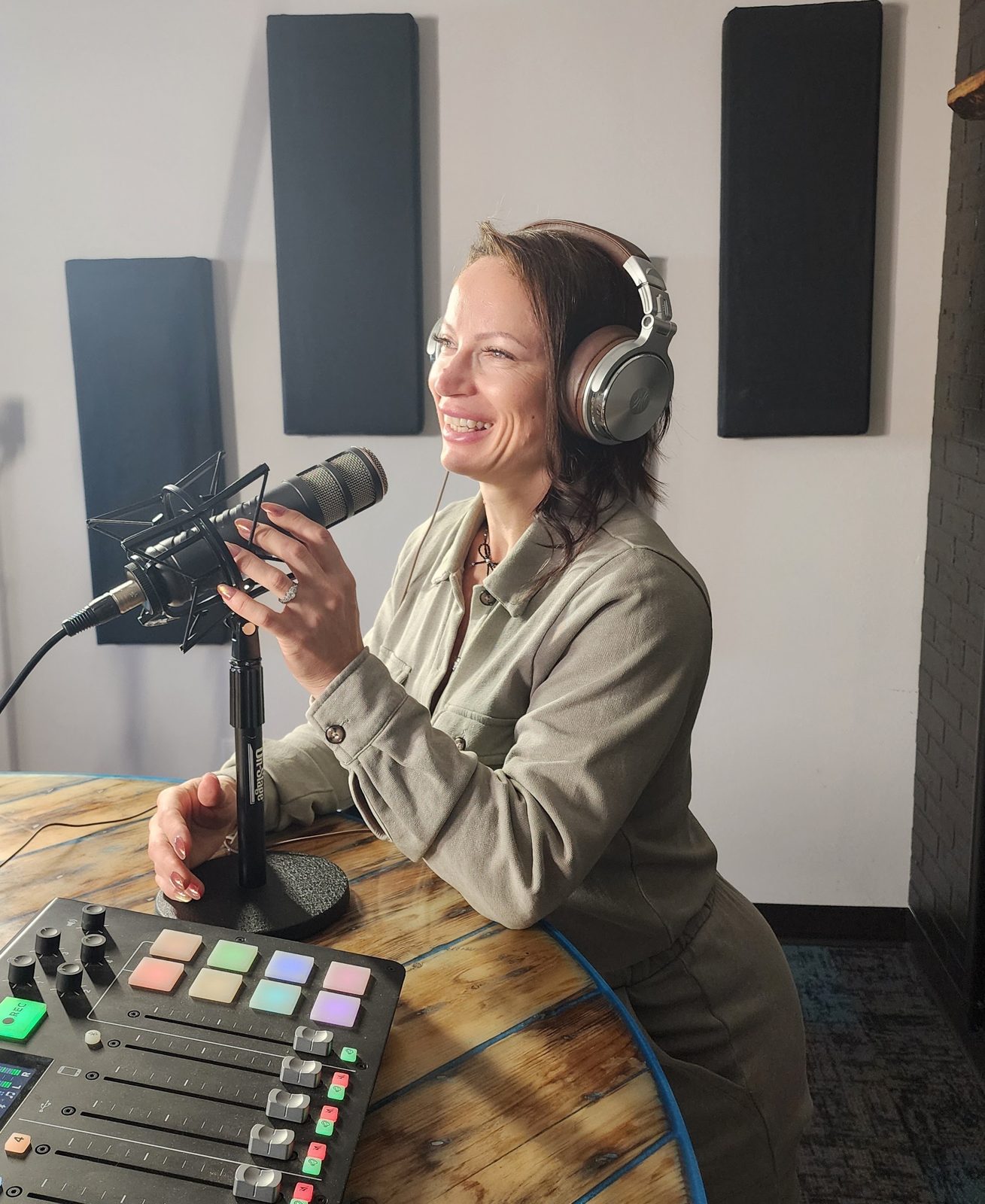Anca Platon Trifan recording at a podcast microphone and mixing board