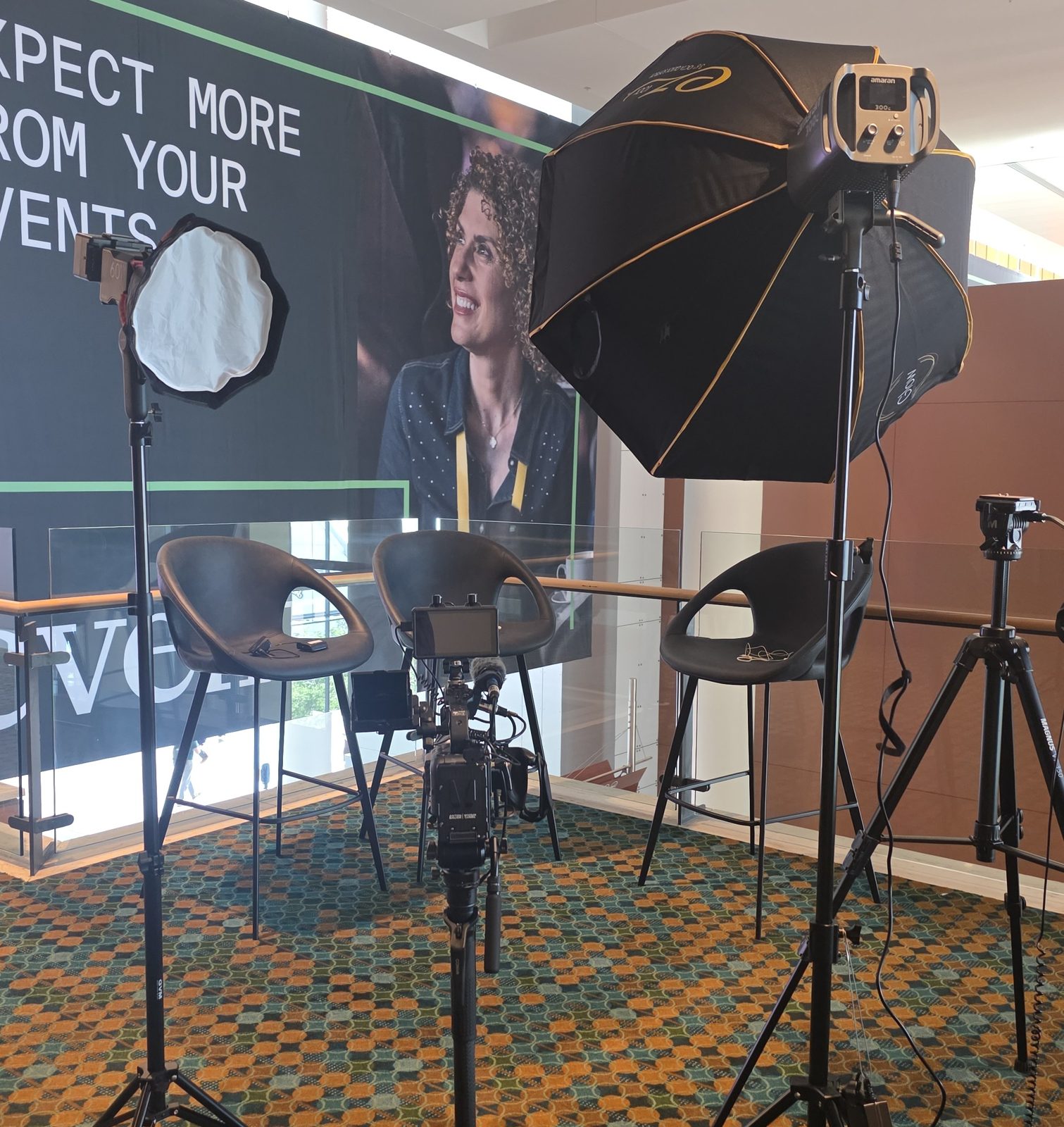 Interview set at a conference with softbox lights and a camera