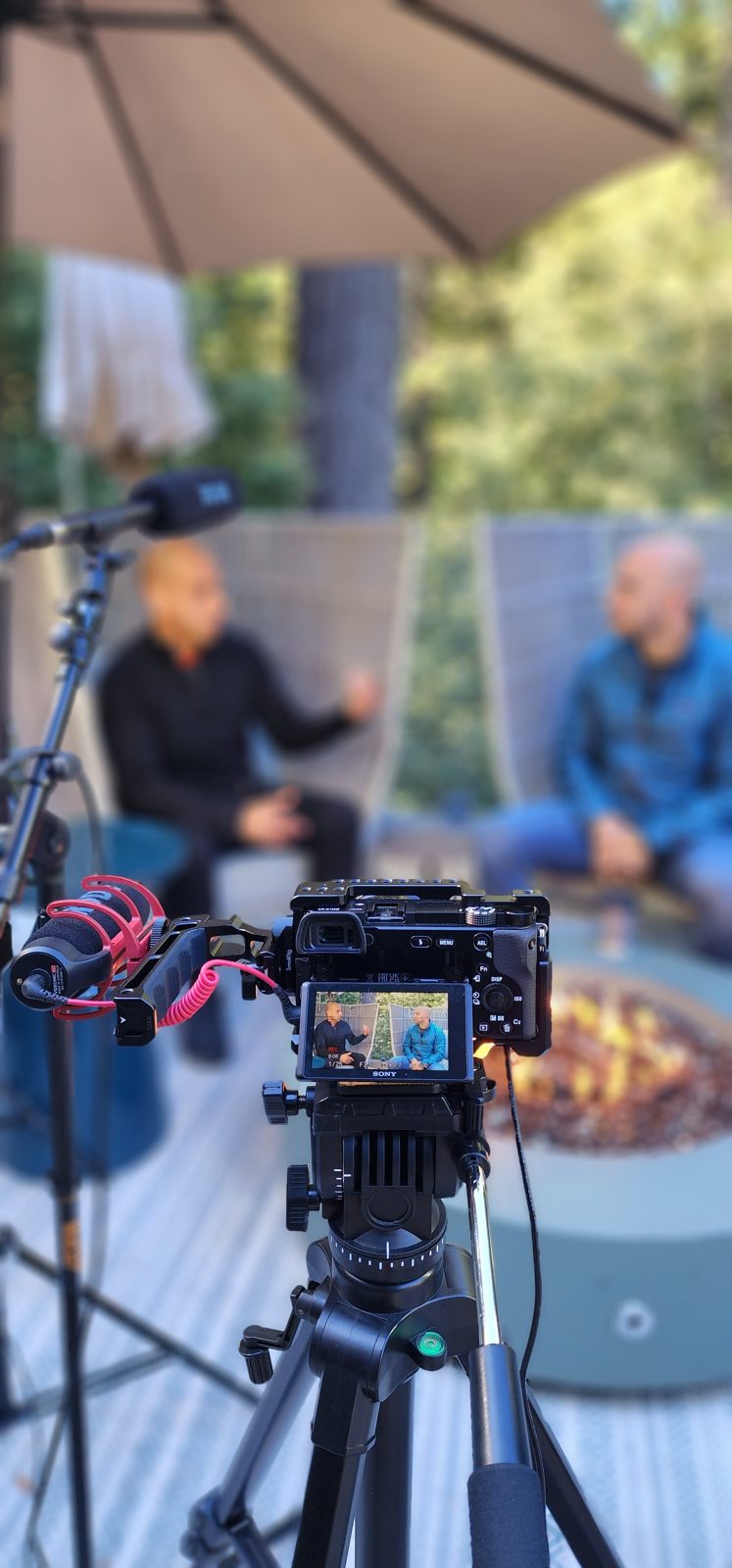 Camera filming an outdoor interview on location
