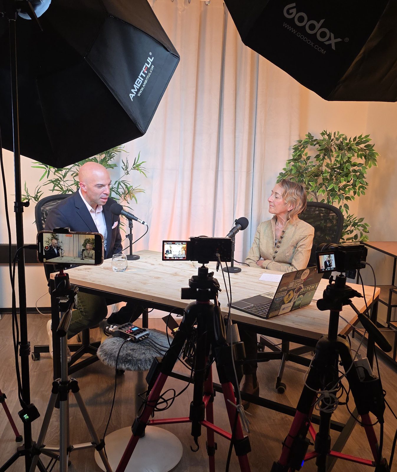 Video podcast interview lit by softboxes and filmed on three cameras